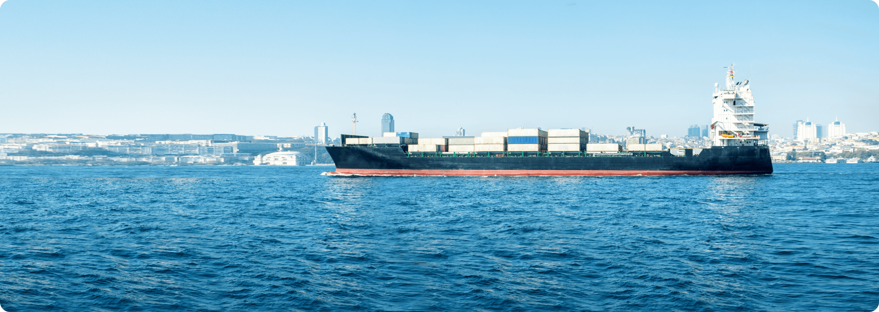 Big cargo ship on a bosphrous with istanbul background
