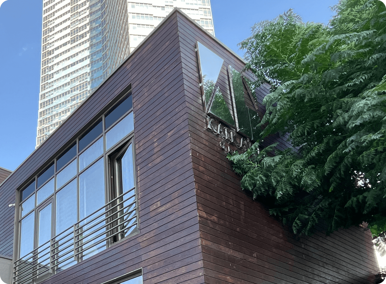 a villa with a Kalkavan global logo on it with trees